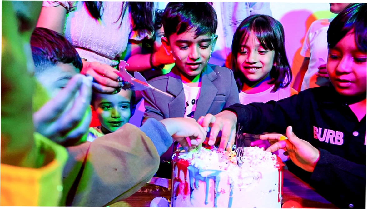 Children celebrating a birthday at MAD Labs inside Snow City Bangalore, enjoying cake and fun together in a vibrant indoor party space.