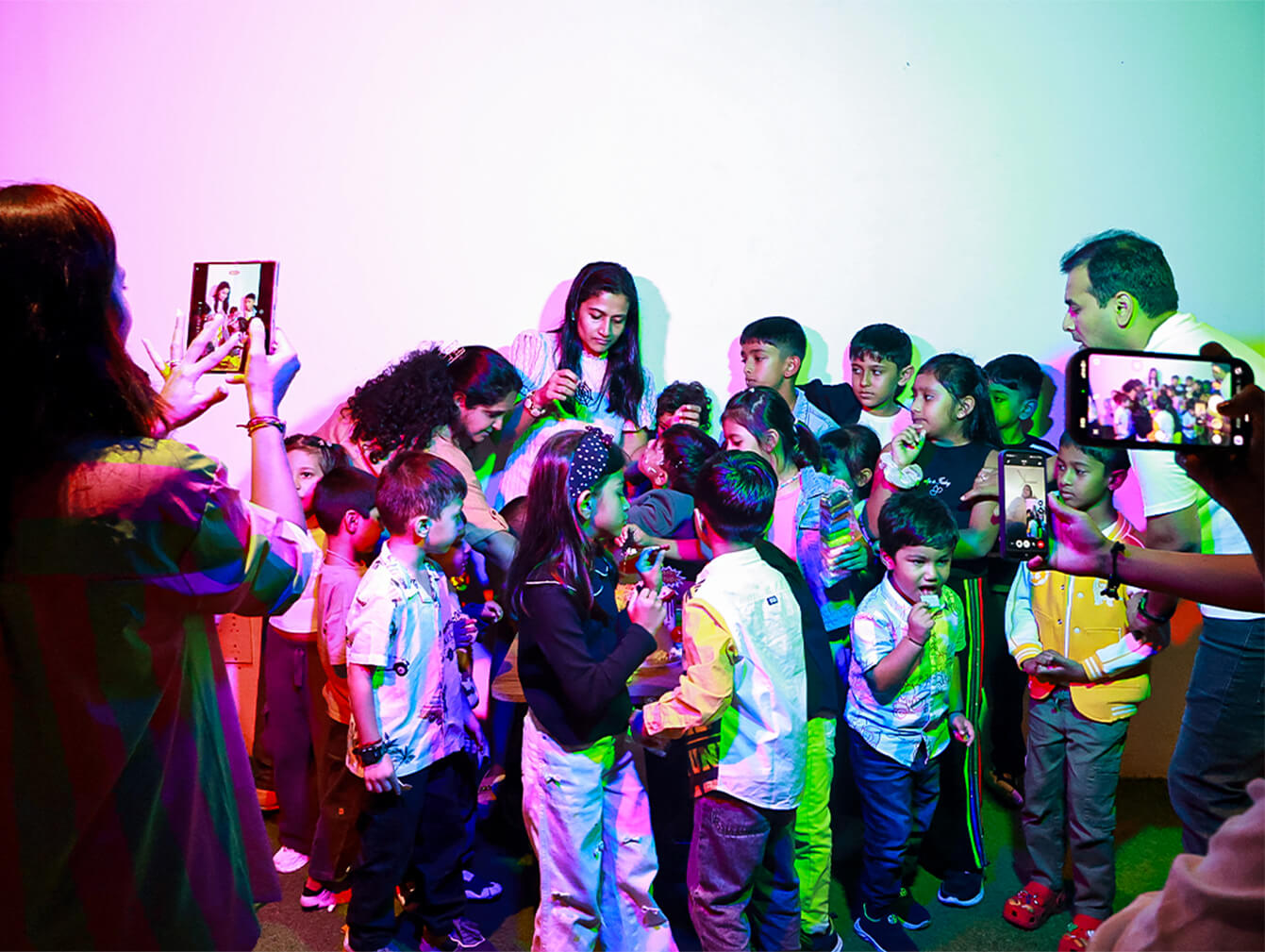 A group of kids enjoying colorful lights and interactive play at MAD Labs, Snow City Bangalore, during a school trip or birthday celebration.